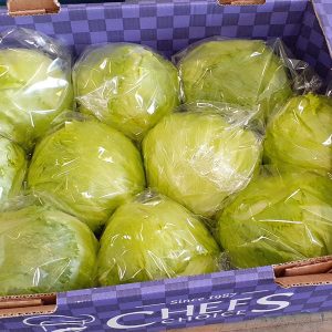 A selection of freshly picked iceberg lettuce laid in a Veg-UK Chefs Choice crate.